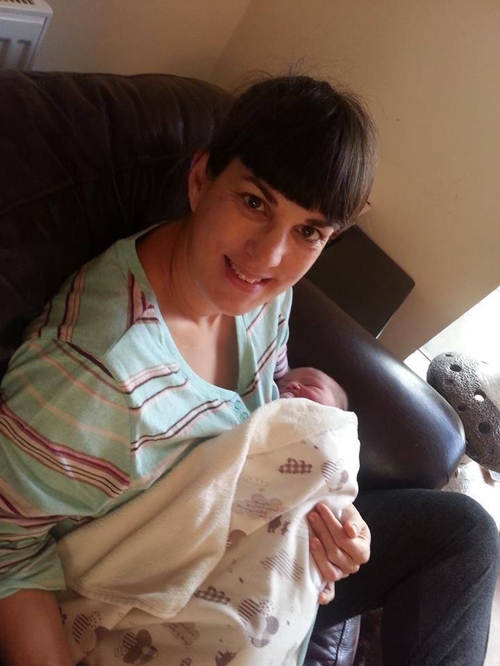 Photo of Jo holding a newborn baby