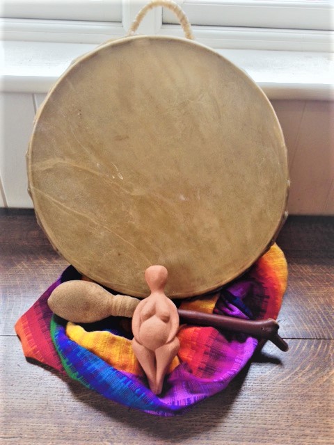 Photo of the tools used in a ceremony - drum, scarves and goddess figure