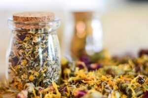Photo showing jar of dried flowers used to help postpartum healing