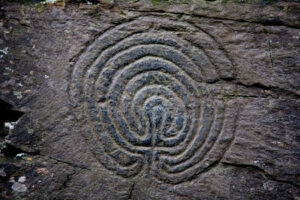 Photo of a labyrinth carved into a stone rock face at rocky Valley near to Tintagel