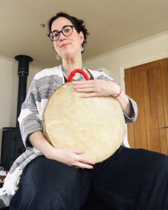 Jo Kidman doula holding a shamanic drum